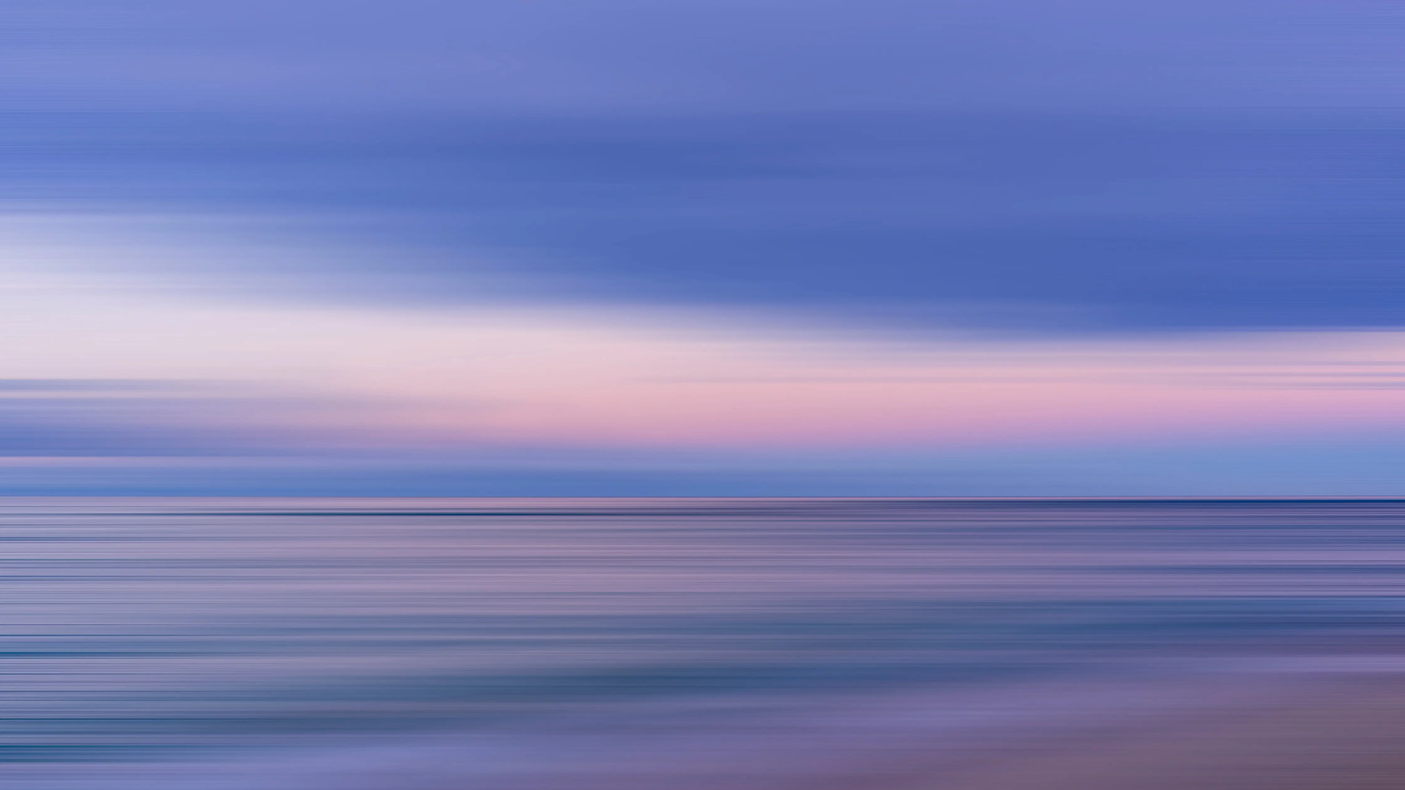 Minimalist horizontal landscape blur representing a peaceful coastal sunrise.
