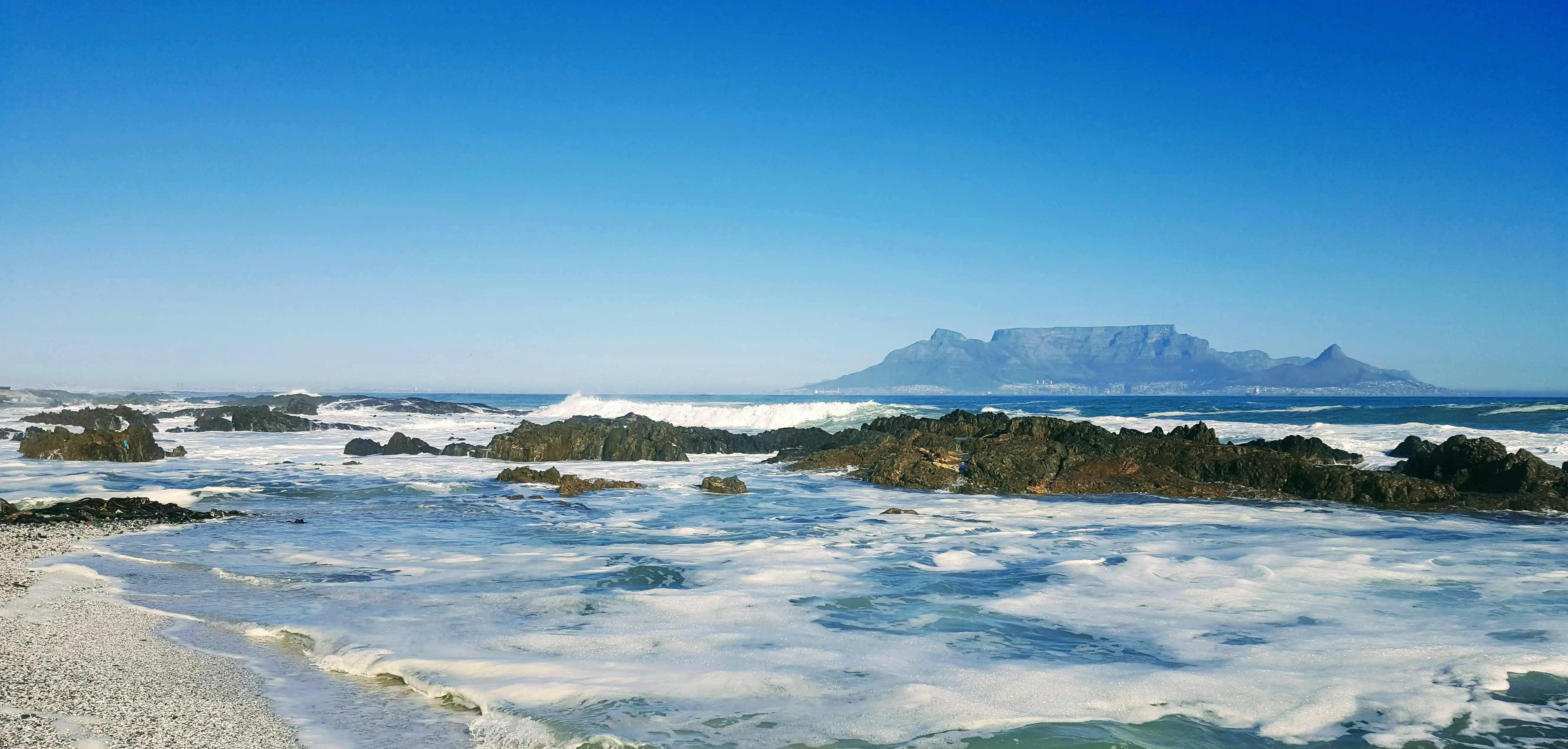 Coastal Cape Town skyline with Table Mountain in the background.