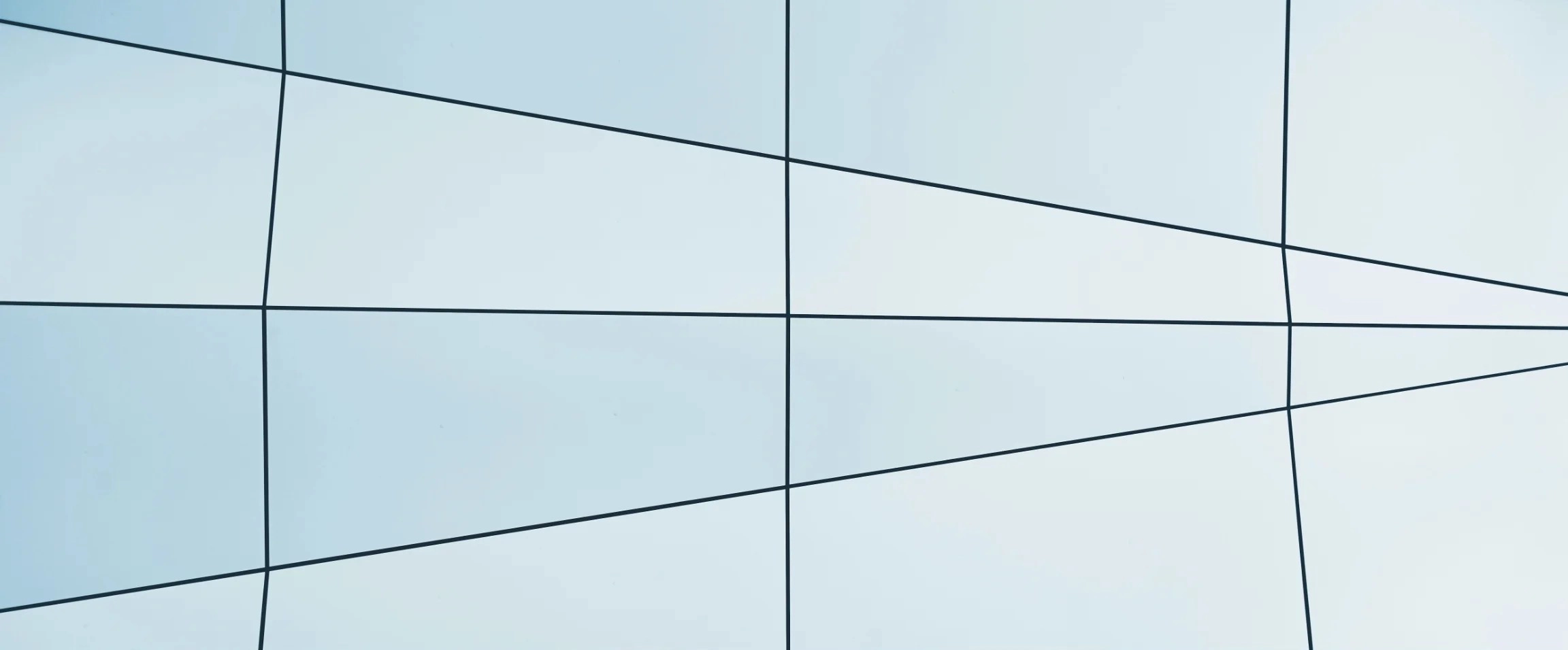Abstract blue architectural glass panels with black grid lines.